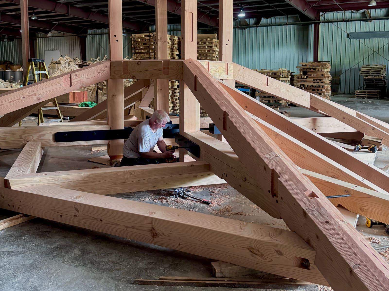 A timber frame bent being assembled in the shop