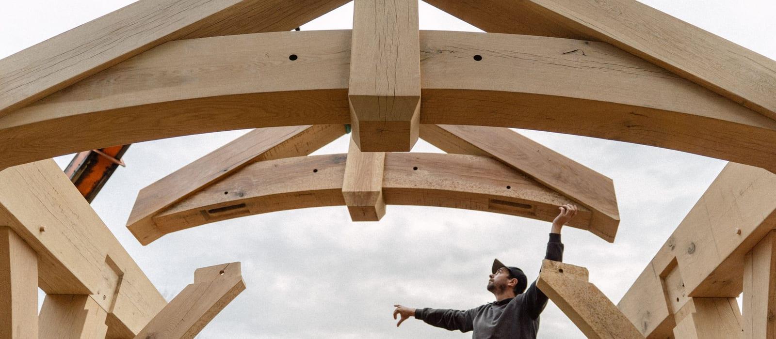 A timber frame going up on raising day